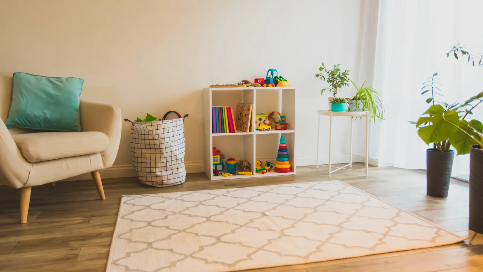 Bright preschool playroom with wooden toys, books and low shelves