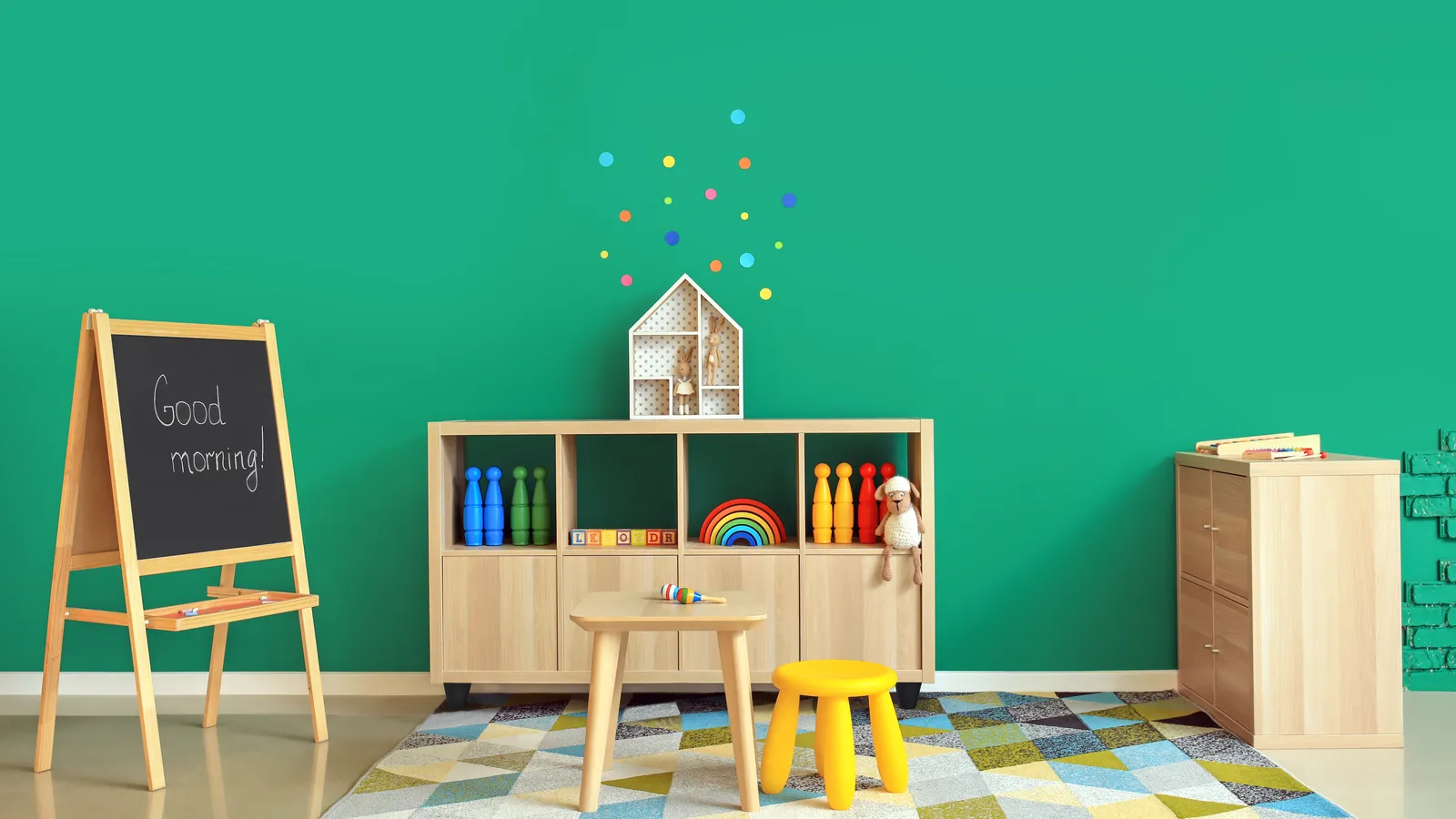 Bright indoor playroom with toys, low shelves and soft seating