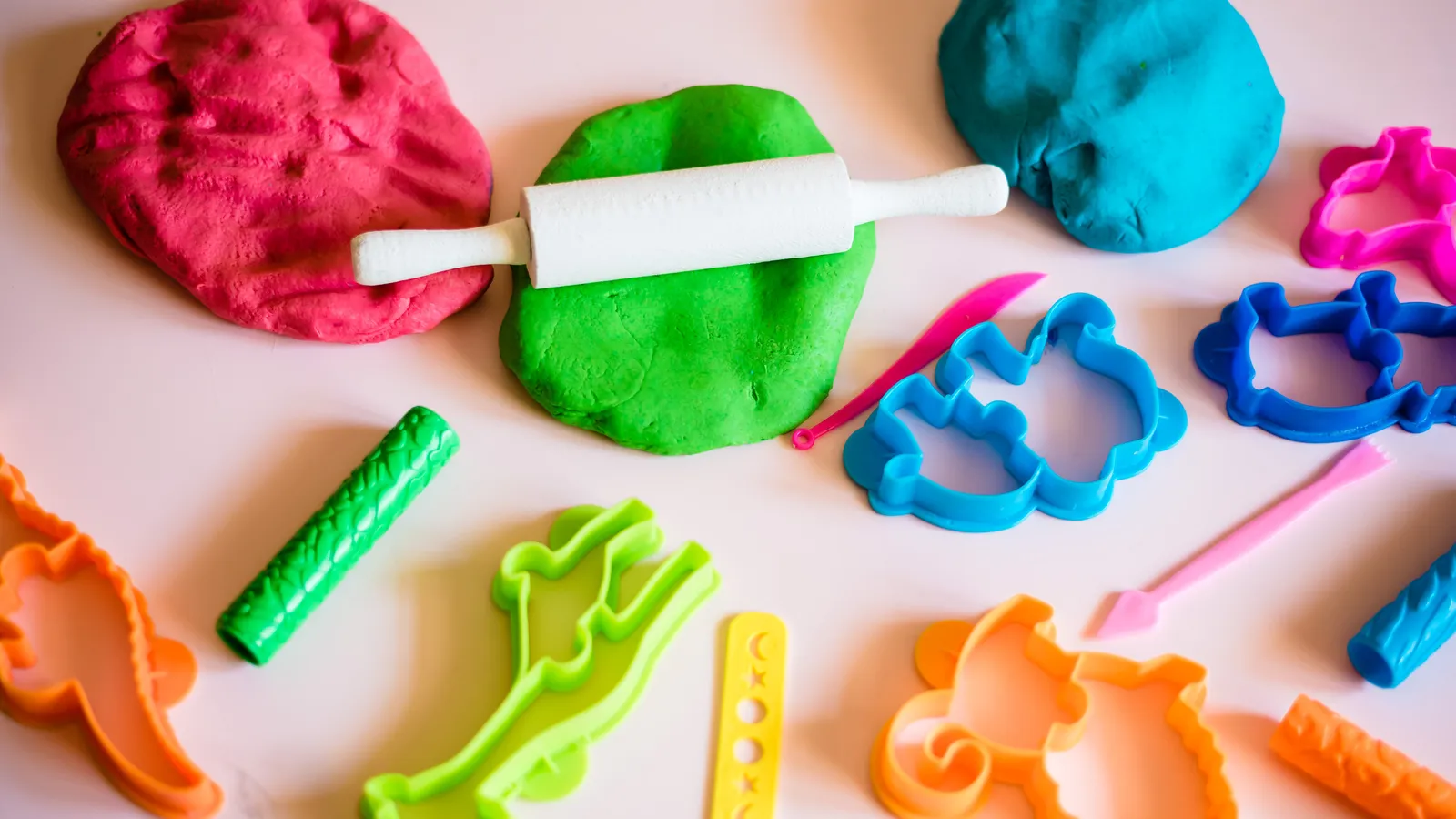 Balls of colourful modelling clay arranged for sensory play