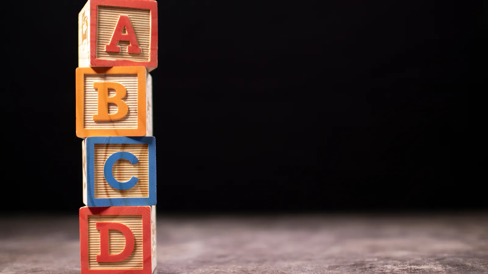 Wooden letter tiles spread out for choosing a baby boy name