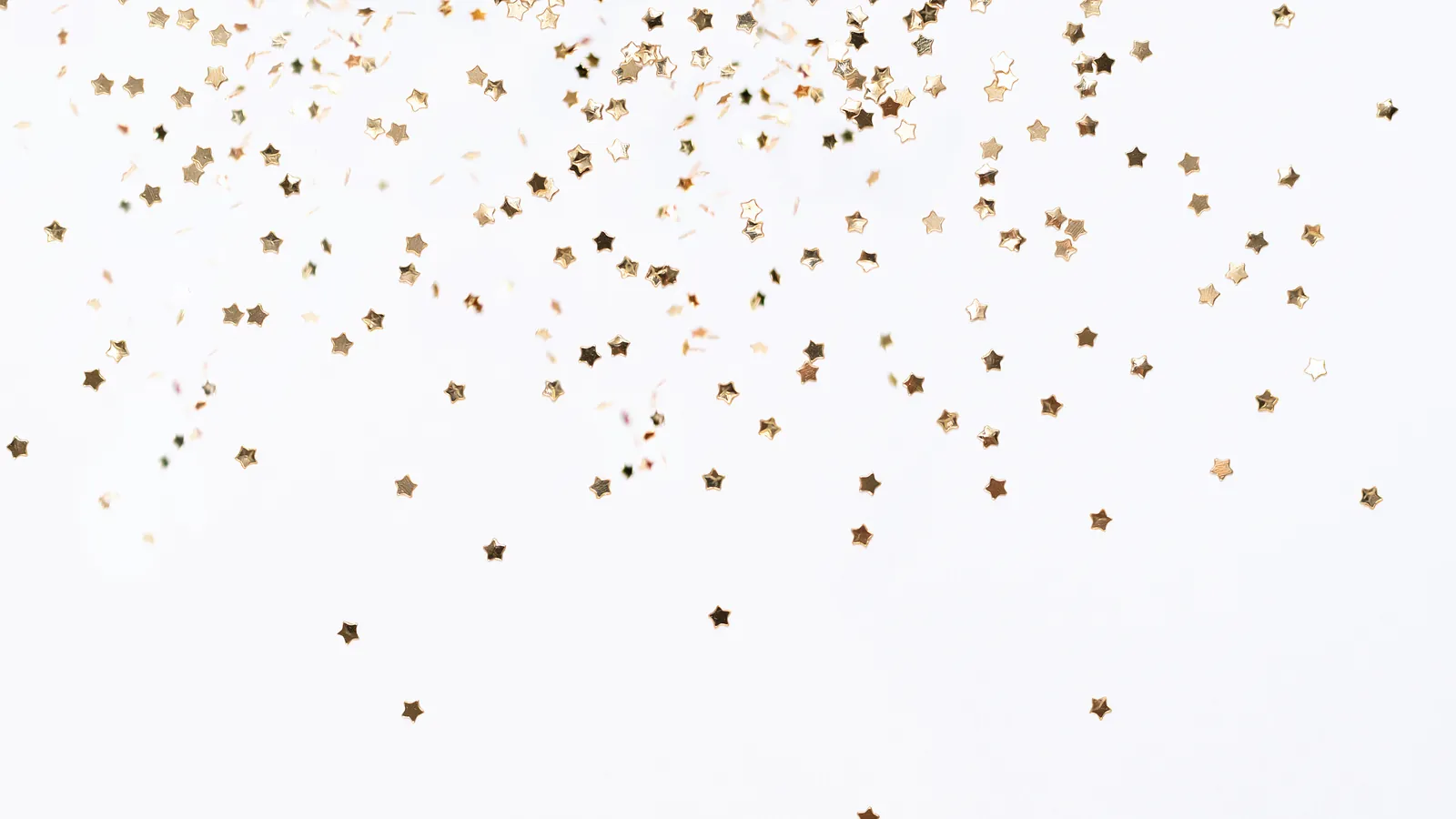 Small gold star-shaped confetti scattered across a plain white background