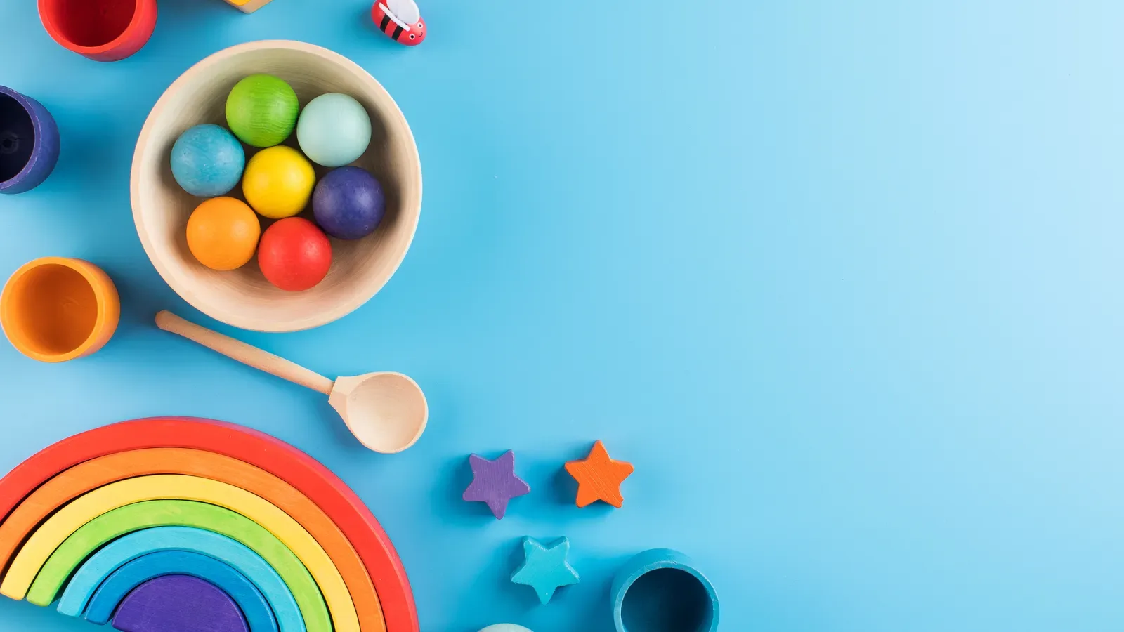 Colorful wooden educational toys arranged on a blue background