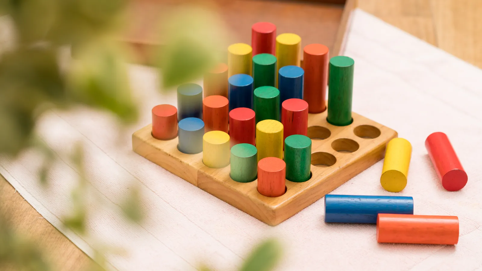Top view of colourful wooden blocks arranged by size for open-ended play