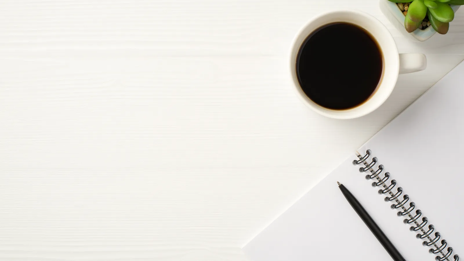 Coffee, a notebook and everyday essentials arranged as a gift set for a new dad