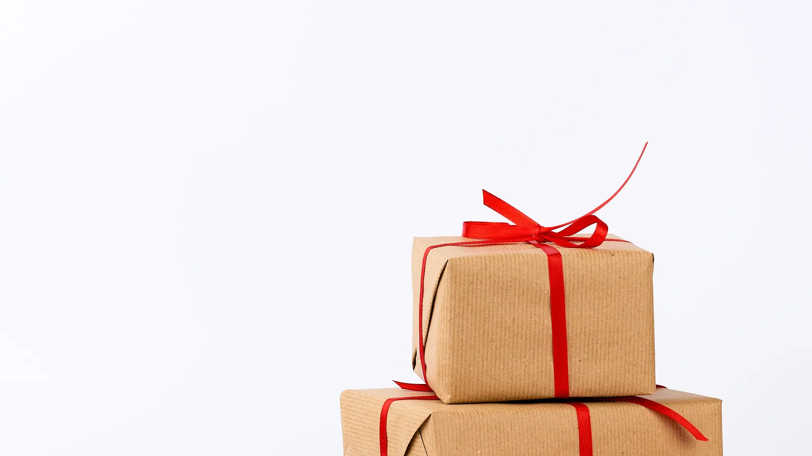 Stack of small gifts wrapped in kraft paper and tied with ribbon