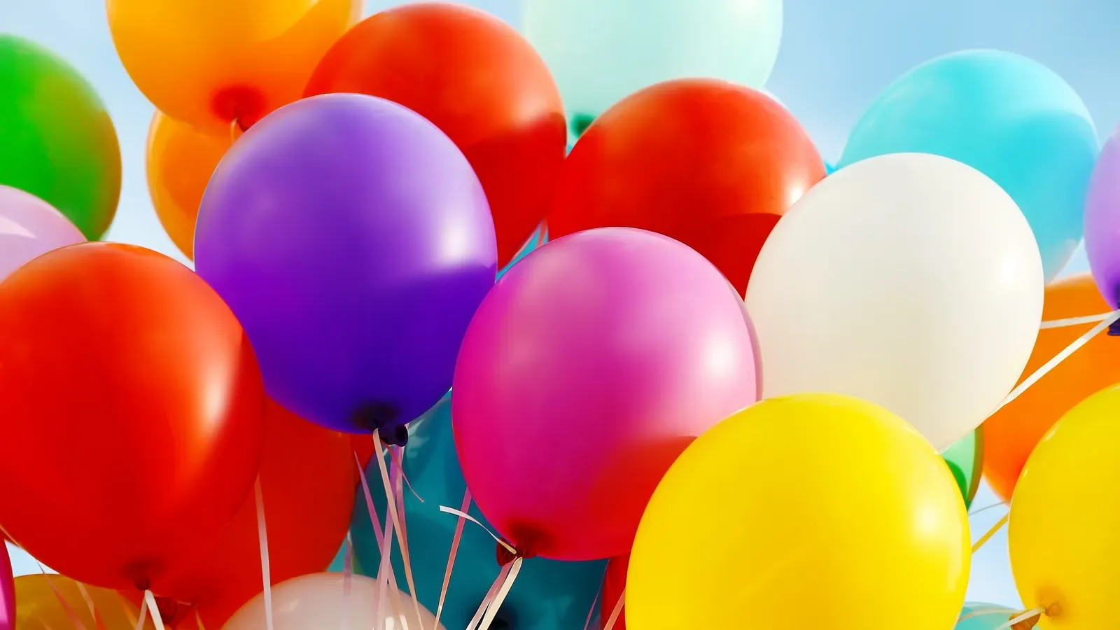 Colorful birthday balloons clustered together in close-up