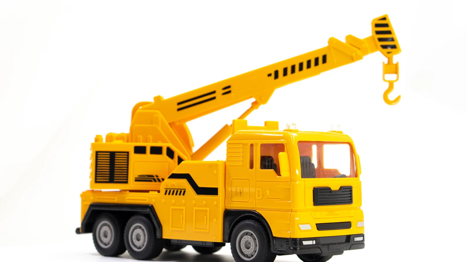 Yellow toy crane truck on a plain white background