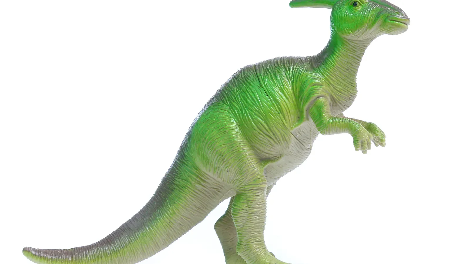 A green toy dinosaur figure standing on a plain white background