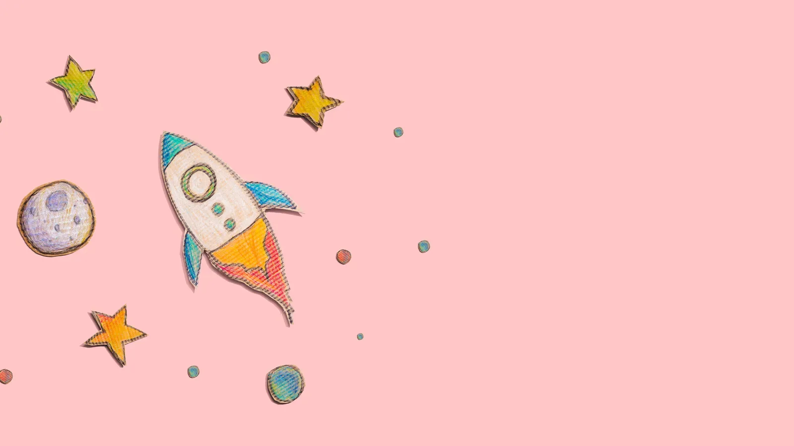 Child-style drawing of a rocket, star and planets on a pink background
