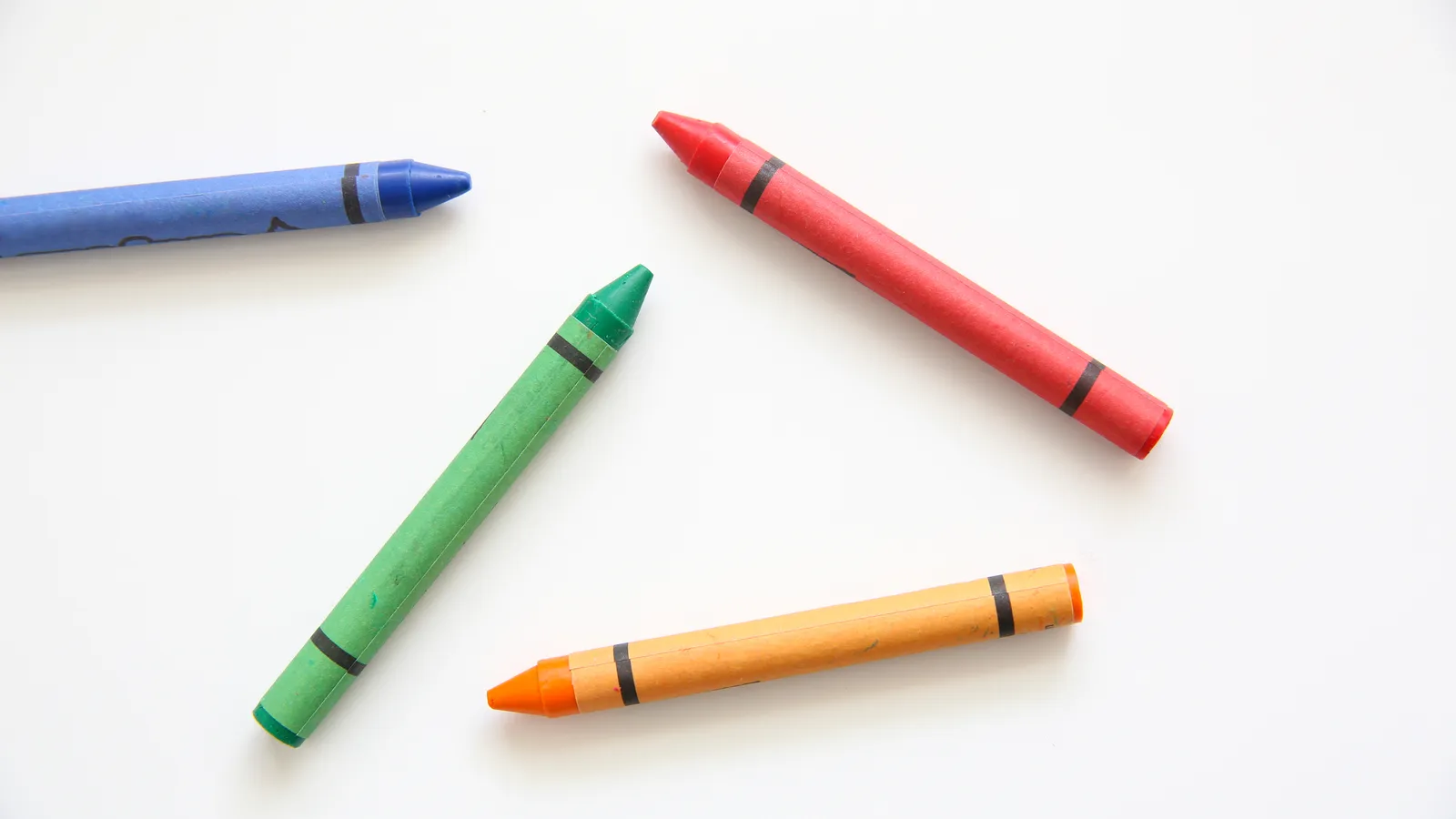 Row of colourful wax crayons ready for toddler colouring pages